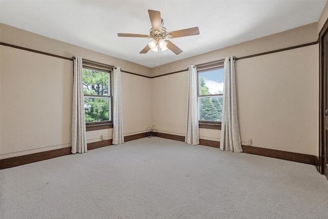 spare room with carpet and ceiling fan