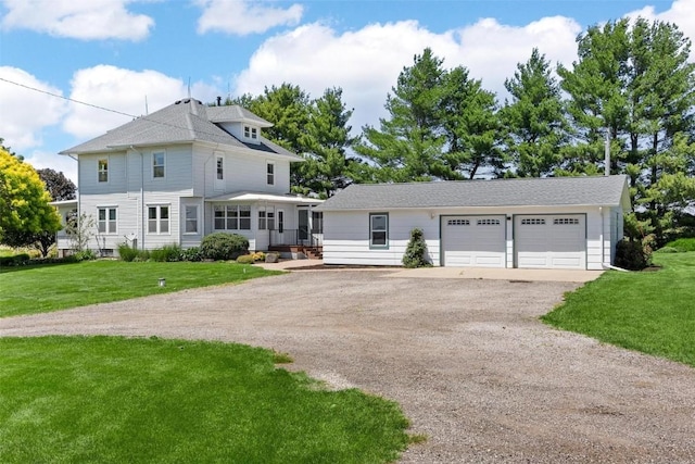 view of front of home with a front lawn and a garage