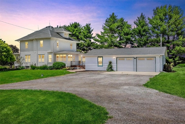 view of front of property featuring a lawn and a garage