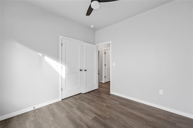 unfurnished bedroom featuring hardwood / wood-style flooring, ceiling fan, and a closet