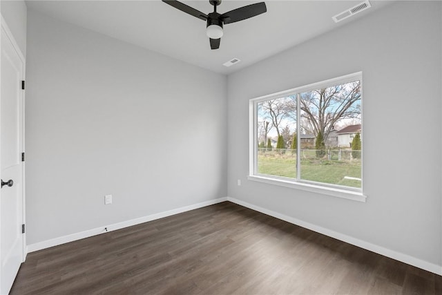 empty room with ceiling fan and dark wood-type flooring