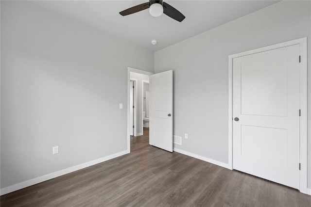 unfurnished bedroom featuring ceiling fan and dark wood-type flooring