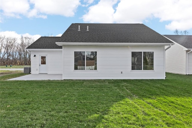 back of property featuring a lawn, central AC, and a patio