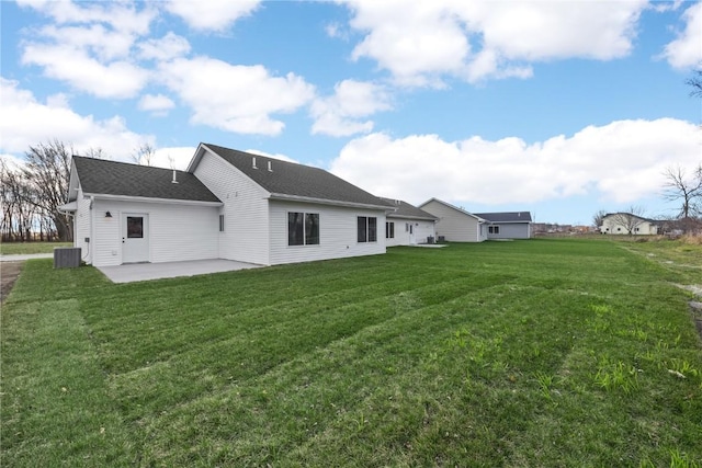 back of property featuring a yard, a patio, and central AC