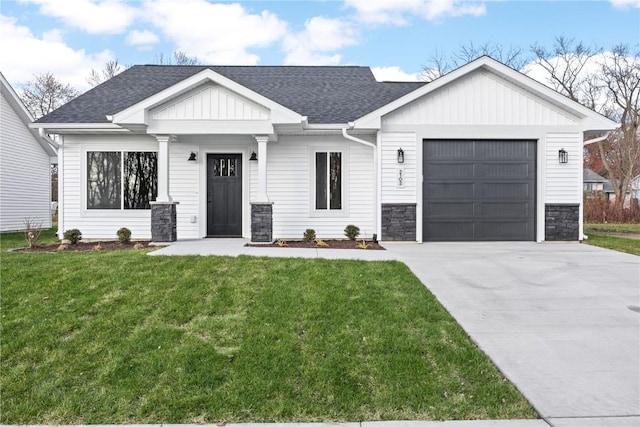 view of front of home with a garage and a front lawn