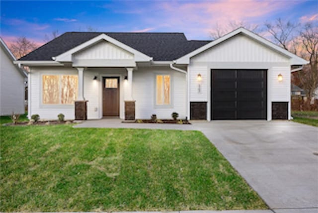 view of front of house with a lawn and a garage