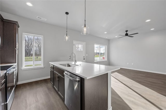 kitchen featuring sink, ceiling fan, an island with sink, decorative light fixtures, and stainless steel appliances