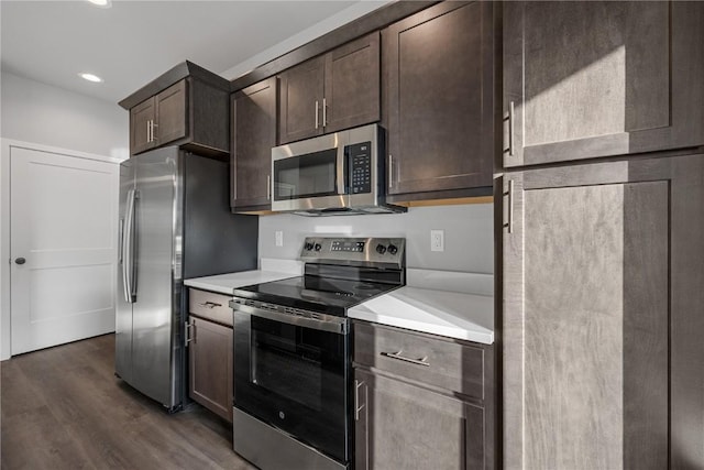 kitchen featuring dark hardwood / wood-style floors, dark brown cabinets, and appliances with stainless steel finishes