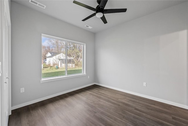 spare room featuring ceiling fan and dark hardwood / wood-style flooring