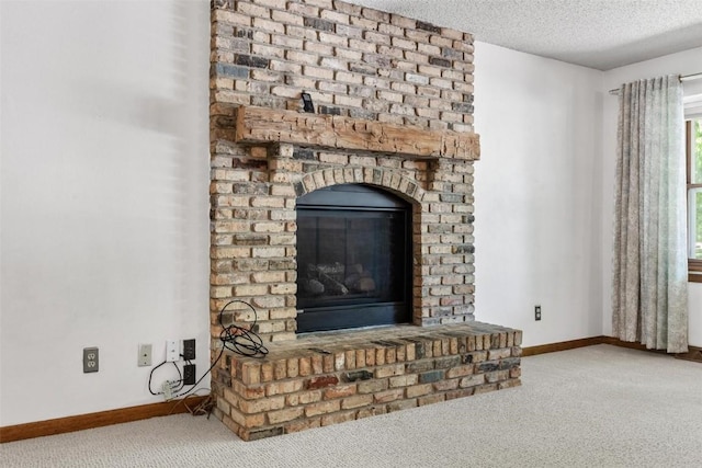 room details featuring carpet flooring, a fireplace, and a textured ceiling