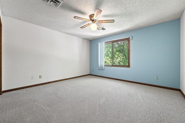 carpeted spare room with ceiling fan and a textured ceiling