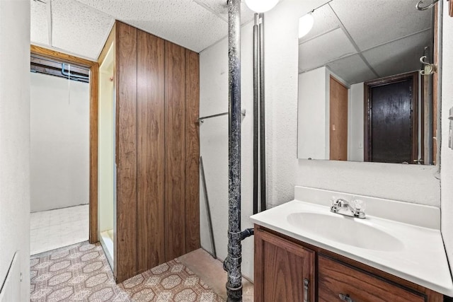 bathroom featuring a drop ceiling and vanity