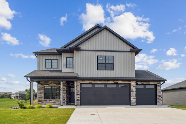 view of front of home featuring a front yard and a garage