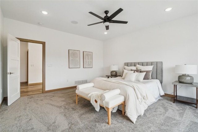 bedroom with ceiling fan and light colored carpet