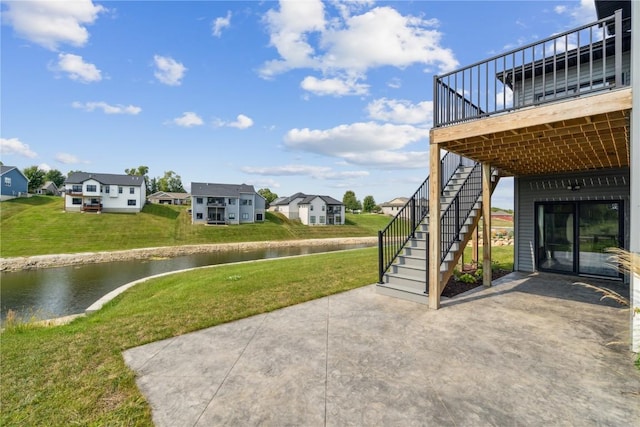 view of yard featuring a patio area and a water view