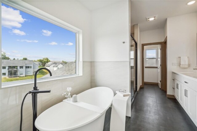 bathroom featuring a washtub and vanity