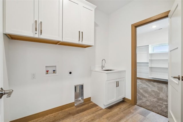 washroom featuring sink, cabinets, washer hookup, electric dryer hookup, and light hardwood / wood-style flooring