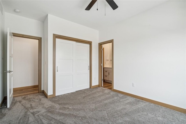 unfurnished bedroom featuring carpet, ceiling fan, ensuite bathroom, and a closet