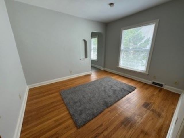 spare room with hardwood / wood-style flooring