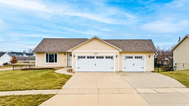 view of front of home with a garage and a front lawn