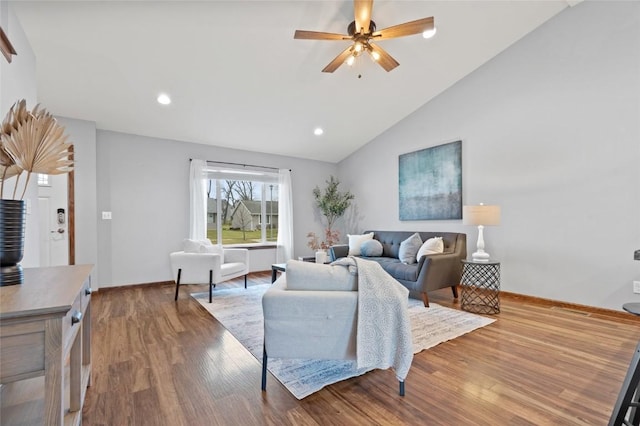 living room with hardwood / wood-style floors, vaulted ceiling, and ceiling fan