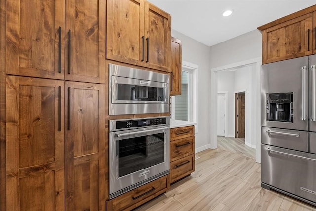 kitchen with stainless steel appliances and light wood-type flooring