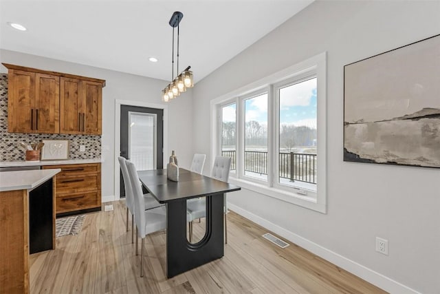 dining space with light wood-type flooring