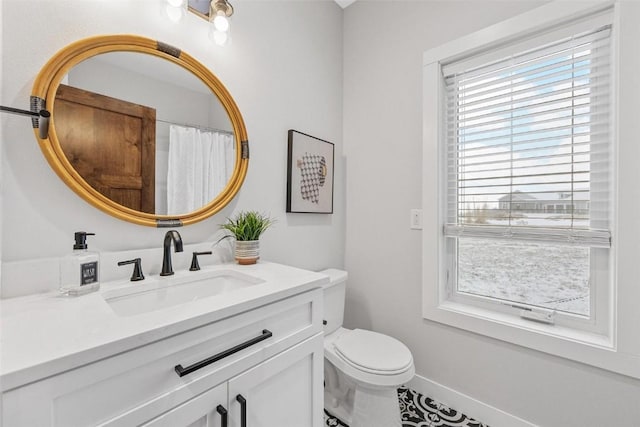 bathroom featuring vanity and toilet