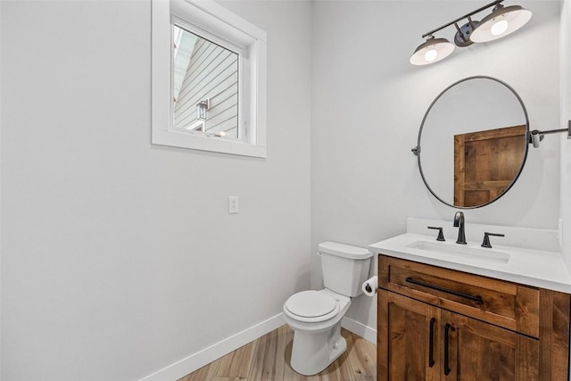 bathroom featuring hardwood / wood-style floors, vanity, and toilet