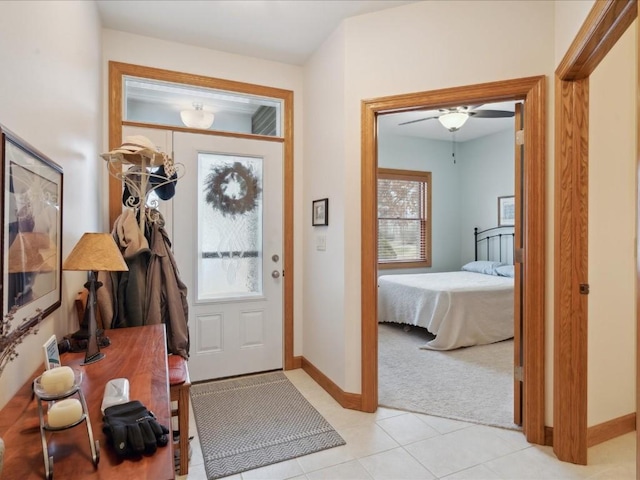 carpeted foyer featuring ceiling fan and a healthy amount of sunlight