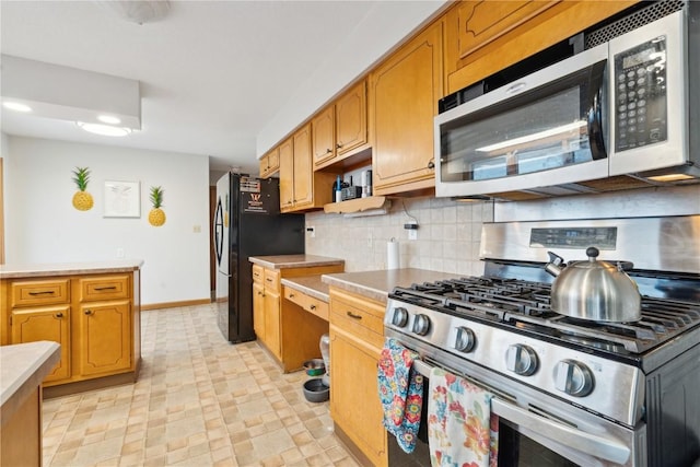 kitchen featuring decorative backsplash and appliances with stainless steel finishes