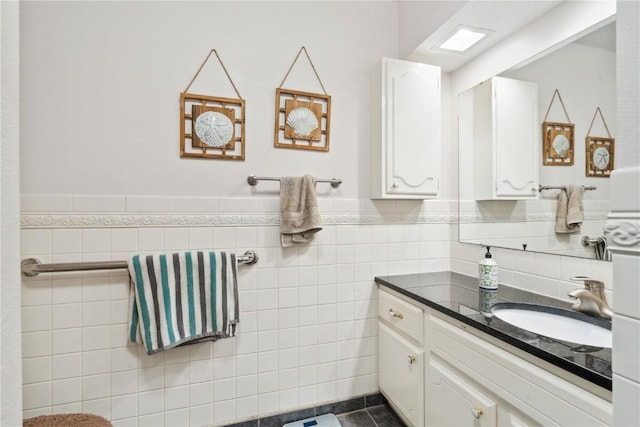 bathroom featuring vanity, tile patterned floors, and tile walls