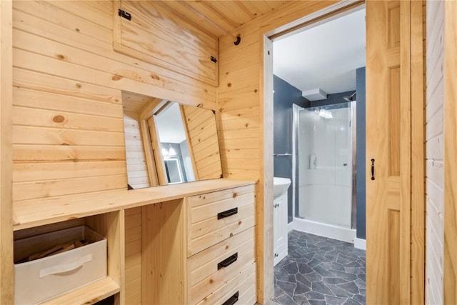 interior space with an enclosed shower and wooden walls