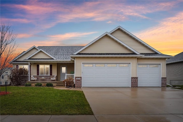 craftsman inspired home featuring a lawn, a porch, and a garage