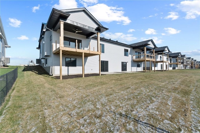 back of house with a lawn, cooling unit, and a balcony