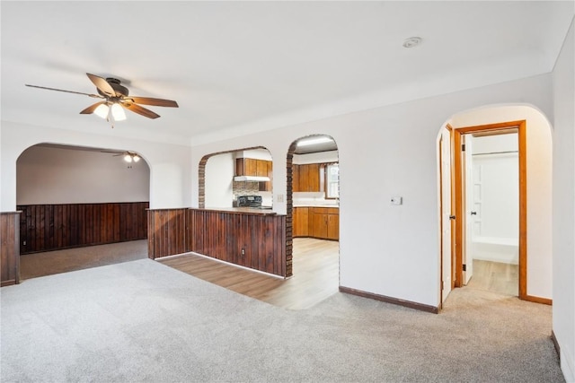 unfurnished room featuring ceiling fan and light carpet