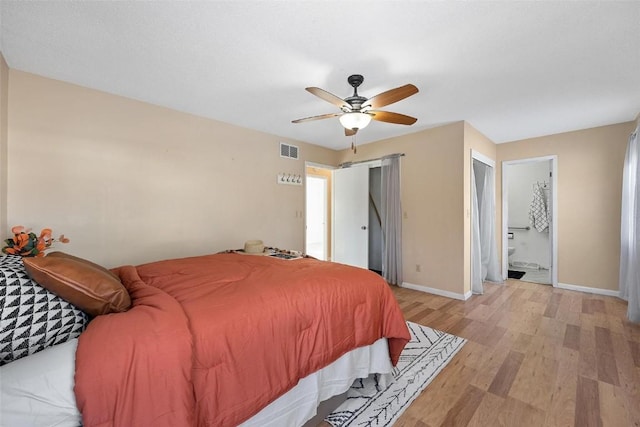 bedroom featuring ceiling fan, ensuite bathroom, and light hardwood / wood-style floors