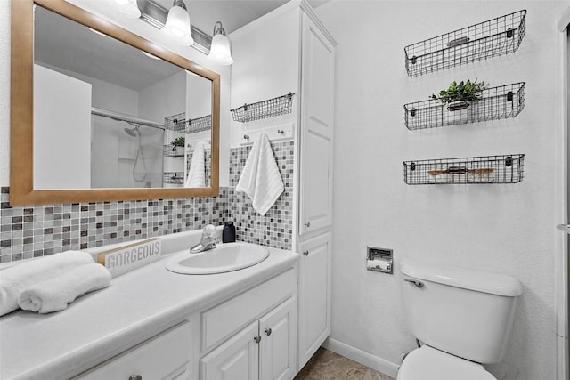 bathroom with vanity, tasteful backsplash, toilet, and an enclosed shower