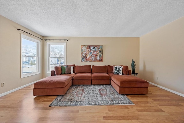 living room featuring a textured ceiling and light hardwood / wood-style floors