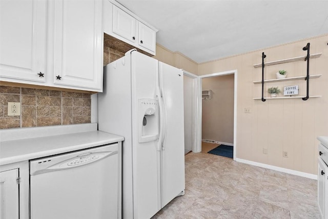 kitchen with white cabinets, decorative backsplash, and white appliances