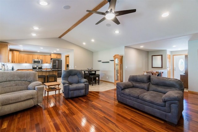 living room with dark hardwood / wood-style flooring, vaulted ceiling, ceiling fan, and sink