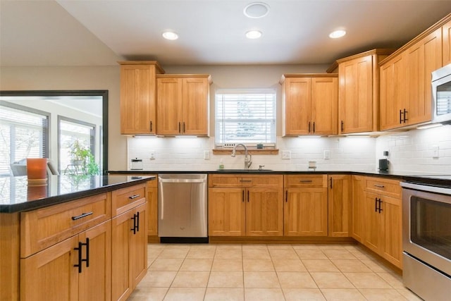 kitchen with light tile patterned flooring, sink, appliances with stainless steel finishes, and tasteful backsplash