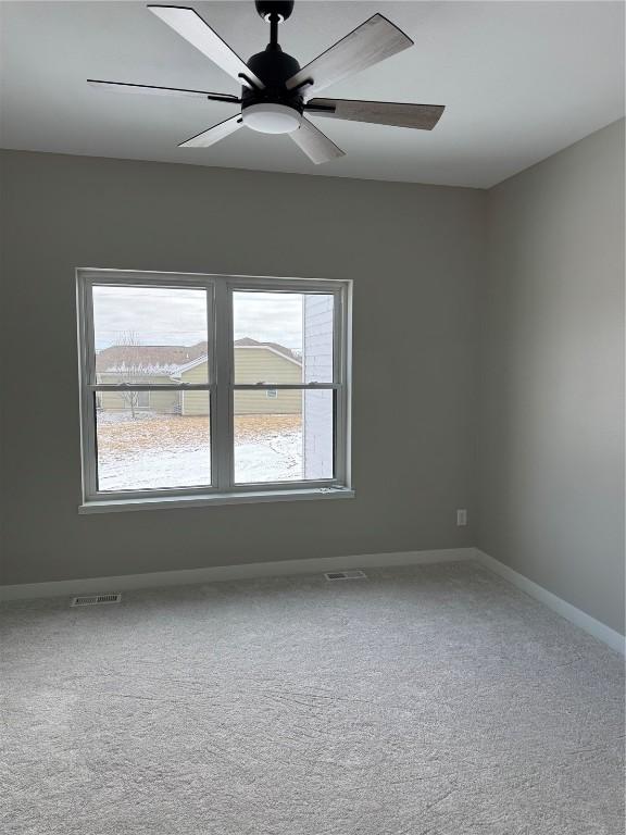 spare room with ceiling fan and carpet floors