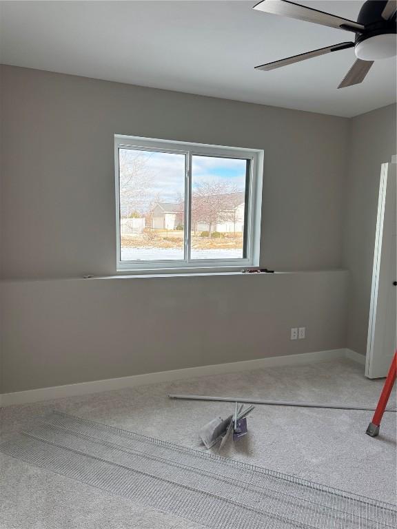 spare room with ceiling fan and a healthy amount of sunlight