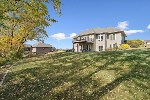 rear view of property featuring a deck and a yard