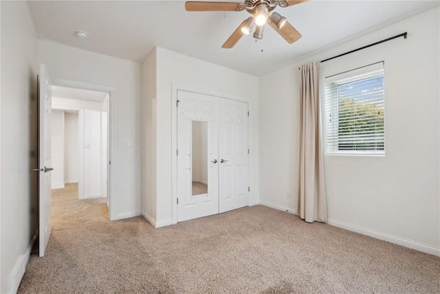 unfurnished bedroom featuring carpet, ceiling fan, and baseboards