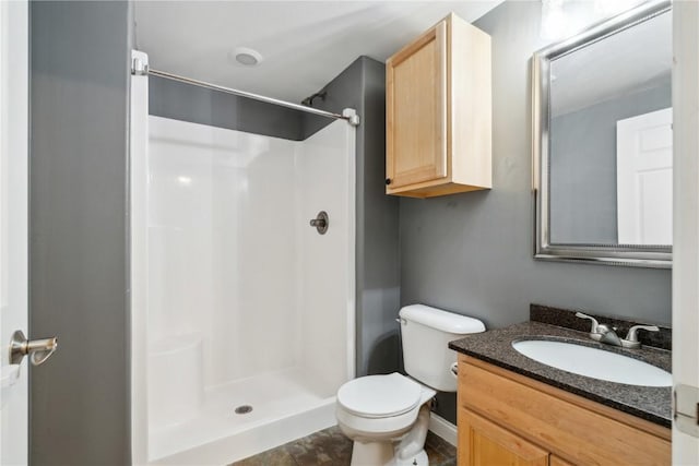 bathroom featuring a stall shower, vanity, and toilet