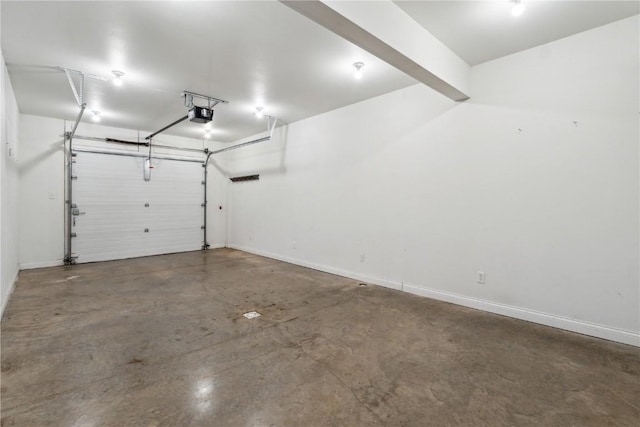 garage featuring a garage door opener and baseboards