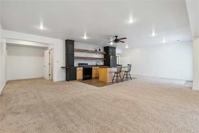 kitchen with black range with electric cooktop, carpet flooring, open floor plan, freestanding refrigerator, and open shelves