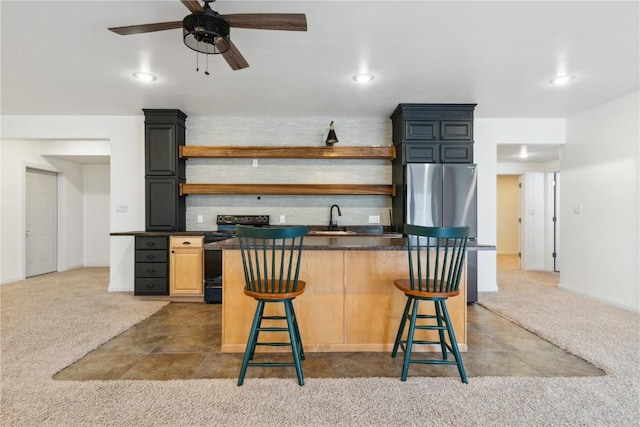 kitchen featuring carpet floors, black / electric stove, open shelves, and freestanding refrigerator